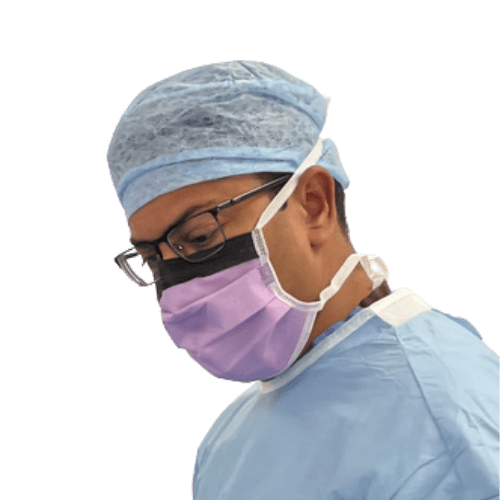 Mr Vasu Karri, consultant plastic surgeon and phenol peel specialist, in surgical attire